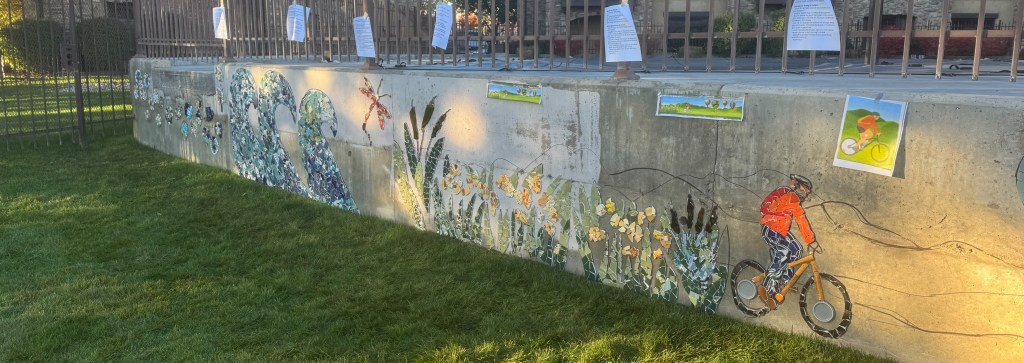 Image of Jodi's bike, flowers, cattails, waves, and the bubble flower garden.